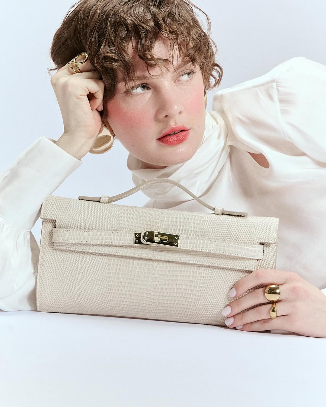 Jade cluch leather bag with retractable handle closure and detachable and adjustable shoulder strap